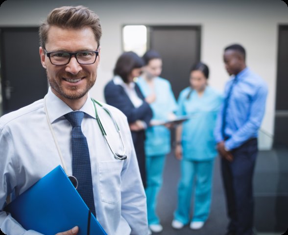 Smiling doctor with healthcare team — workforce management